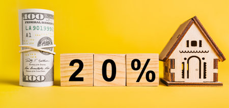 20 interest with house miniature model and money on a yellow background. Investment, real estate, home, housing, earnings, financial conceptの写真素材