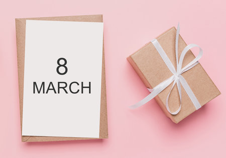 Gifts with note letter on isolated pink background, love and valentine concept with text 8 marchの写真素材