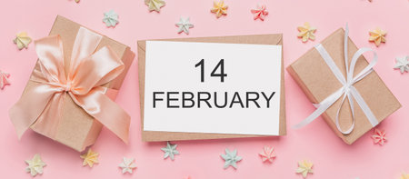 Gifts with note letter on isolated pink background with sweets, love and valentine concept with text14 februaryの写真素材