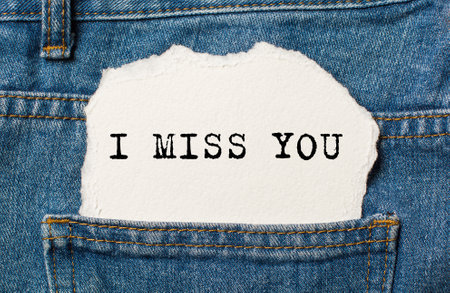 I miss you on torn paper background on jeans love and valentine conceptの写真素材