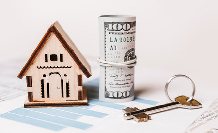 House miniature model and money on documents. Investment, real estate, home, housingの写真素材
