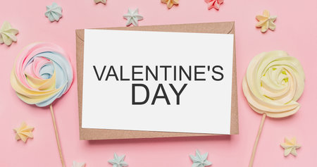 Gifts with note letter on isolated pink background with sweets, love and valentine concept with text Valentines Dayの写真素材