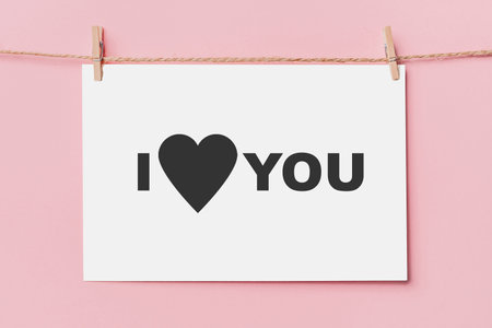 note letter pin on rope on pink background, love and valentine concept I love youの写真素材