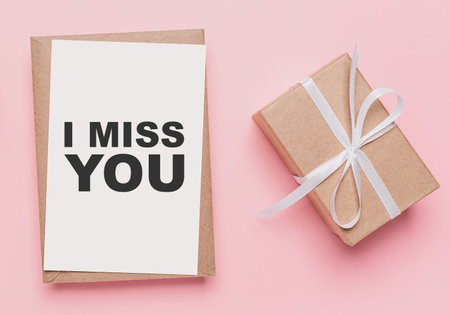 Gifts with note letter on isolated pink background, love and valentine concept with text I miss youの写真素材