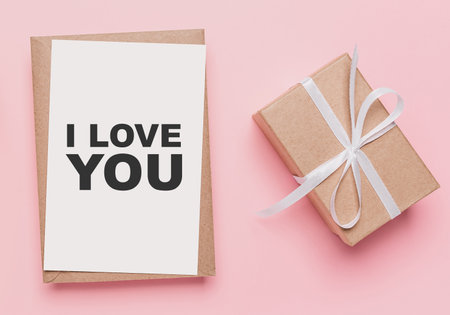 Gifts with note letter on isolated pink background, love and valentine concept with text I love youの写真素材