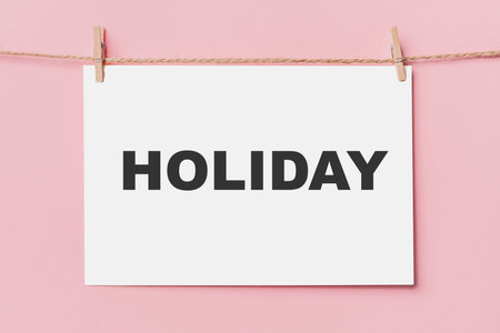 note letter pin on rope on pink background, love and valentine concept with text holidayの写真素材