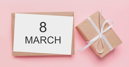 Gifts with note letter on isolated pink background, love and valentine concept with text 8 marchの写真素材