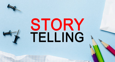 Text Storytelling on a white notepad with pencils on a blue background. Business conceptの写真素材