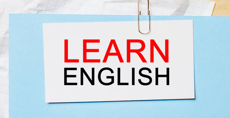 Learn ENGLISHon a white card on a blue background. Business conceptの写真素材