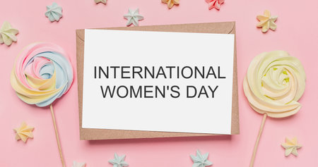Gifts with note letter on isolated pink background with sweets, love and valentine concept with text International Womens Dayの写真素材