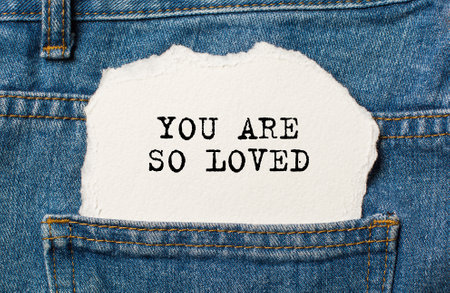 love on torn paper background on jeans love and valentine conceptの写真素材