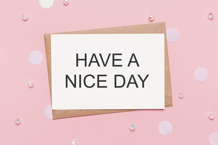 Gifts with note letter on isolated pink background, love and valentine concept with text HAVE A NICE DAYの写真素材