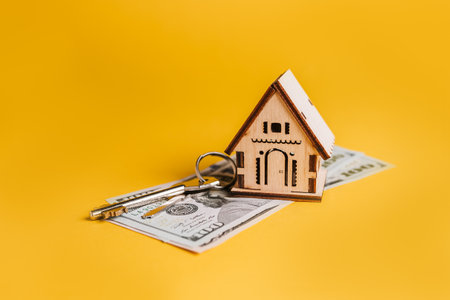 House miniature model, keys and money on a yellow background. Investment, real estate, home, housingの写真素材