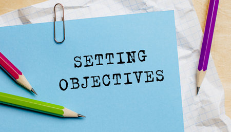Setting Objectives text written on a paper with pencils in officeの写真素材