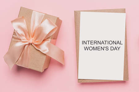 Gifts with note letter on isolated pink background, love and valentine concept with text International Womens Dayの写真素材