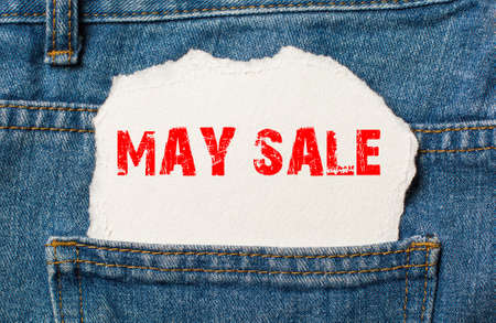 May sale on white paper in the pocket of blue denim jeansの写真素材