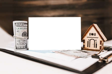 House miniature model and money with blank background on documents. Investment, real estate, home, housingの写真素材