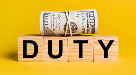 duty with money on a yellow background. The concept of business, finance, credit, income, savings, investments, exchange, taxの写真素材