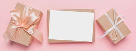 Gifts with note letter on isolated pink background, love and valentine conceptの写真素材
