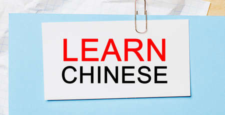 Learn Chinese on a white card on a blue background. Business conceptの写真素材