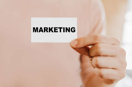 Man holding a business card with Marketingの写真素材