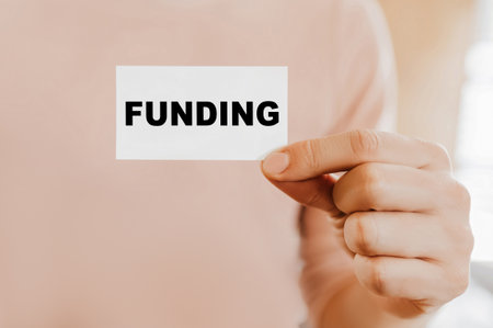 Man holding a business card with Fundingの写真素材