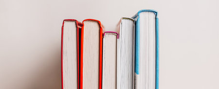A stack of books on white background. Mock up with education and reading concept. Literature for learning, development and joyの写真素材