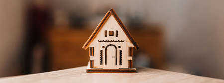 Sweet home. Wooden house on table with blurred backgroundの写真素材