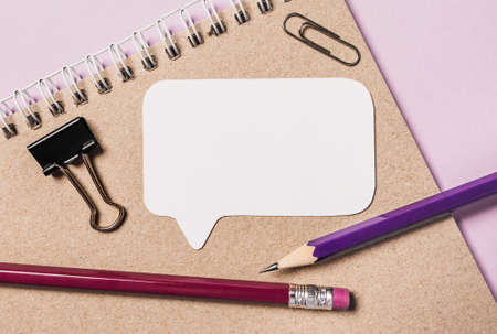 Notepad, white sticker and pensil on the desk. Mock up in copy space office purple background. It is important not to forget the noteの写真素材
