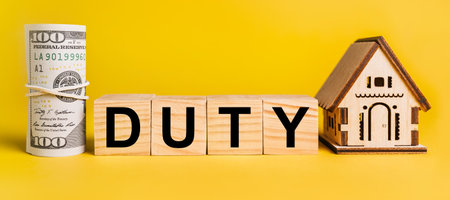 duty with house miniature model and money on a yellow background. The concept of business, finance, credit, tax , real estate, home, housingの写真素材