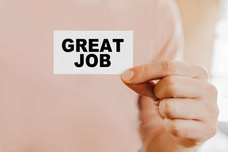 Man holding a business card with Great Jobの写真素材