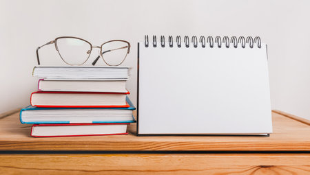 white notepad, books and glasses on workplace. Mock up in copy space office purple background. It is important not to forget the noteの写真素材