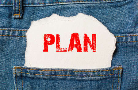 Plan on white paper in the pocket of blue denim jeansの写真素材