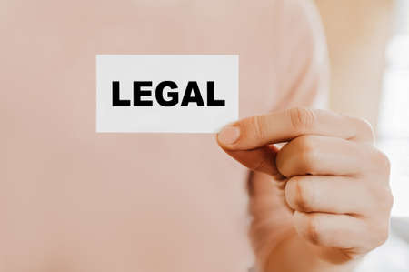 Man holding a business card with Legalの写真素材