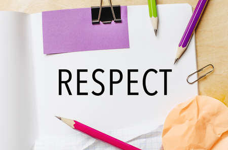 Text RESPECT on a white notepad with pencils on a wooden background. Business conceptの写真素材