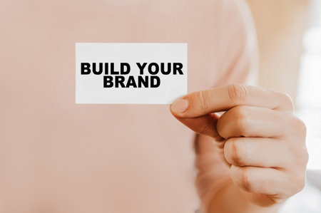 Man holding a business card with Build Your Brandの写真素材