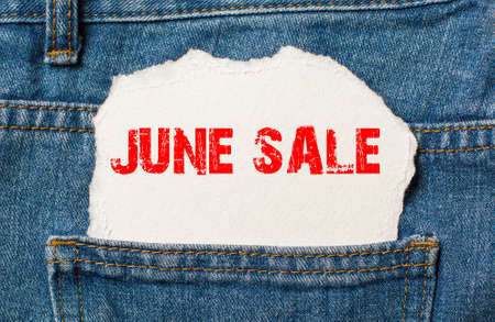 june sale on white paper in the pocket of blue denim jeansの写真素材