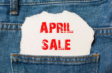 april sale on white paper in the pocket of blue denim jeansの写真素材