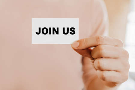Man holding a business card with Join Usの写真素材