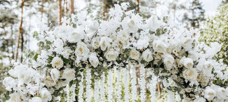 Arch decor with white flowers for a wedding ceremony in natureの写真素材