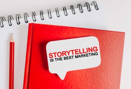 Text Storytelling is the best marketing on a white sticker with office stationery background. Flat lay on business, finance and development conceptの写真素材