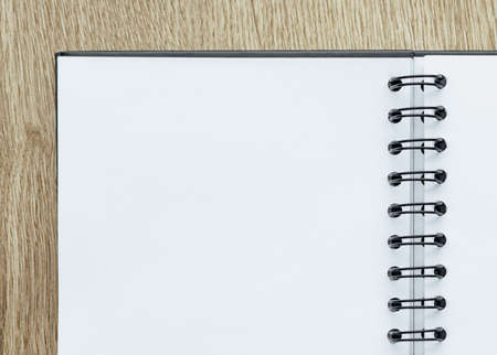 Pen and Notepad on the wooden desk. Business concept, blank sheet with place for advertising and lettering. Education and training supplies.の写真素材