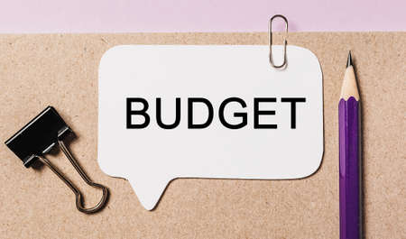 Text Budget on a white sticker with office stationery background. Flat lay on business, finance and development conceptの写真素材