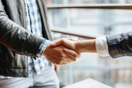 Man and woman hand shaking. Handshake after good cooperation, Businesswoman Shaking hands with Professional businessman after discussing good deal of contract. Business concept.の写真素材