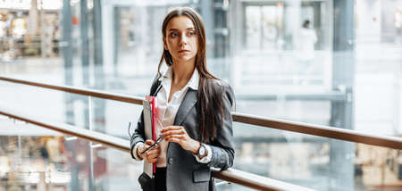 Businesswoman with documents for work. Student girl with folders with documentation. An officer will collect information.の写真素材