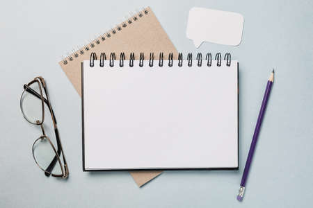 Notepad, white sticker, pensil and glasses on the desk. Mock up in copy space office background. It is important not to forget the noteの写真素材