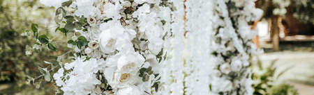 Arch decor with white flowers for a wedding ceremony in natureの写真素材