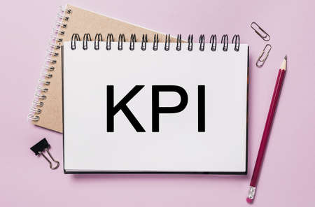 Text KPI on a white sticker with office stationery background. Flat lay on business, finance and development conceptの写真素材