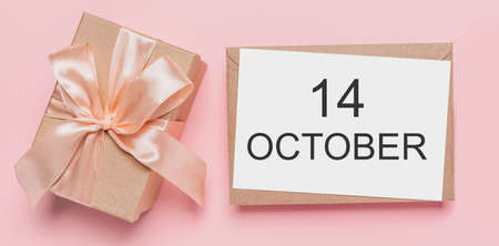 Gifts with note letter on isolated pink background, love and valentine concept with text 14 Octoberの写真素材