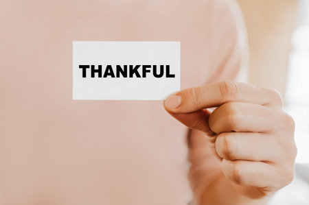 Man holding a business card with Thankfulの写真素材